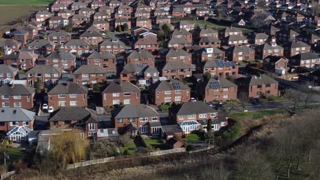 Typical-Suburban-village-residential-Lake-district-neighbourhood-property-rooftops-aerial-view-pull-back