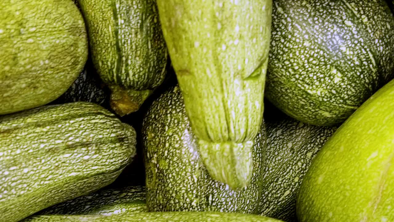 A vibrant display of fresh courgettes at a local farmers market, highlighting organic, healthy, and nutritious produce perfect for vegetarian and farm-to-table lifestyles.