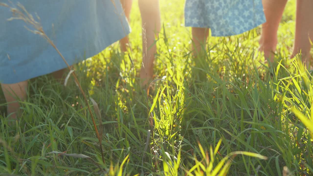 Children Walking Barefoot in Grass
