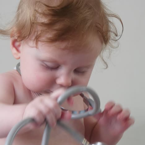 baby playing with stethoscope