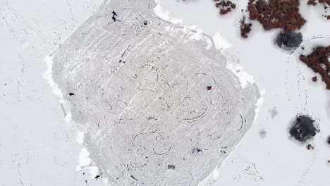 people ice skating on the ice lake. top aerial view