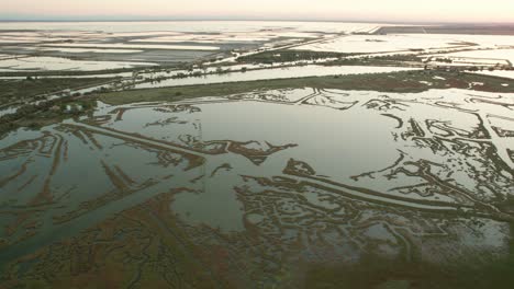 the valli di comacchio lagoon and wetland, drone push in tilt down view during day