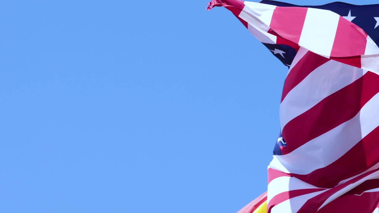 American and Spanish flags waving in the wind