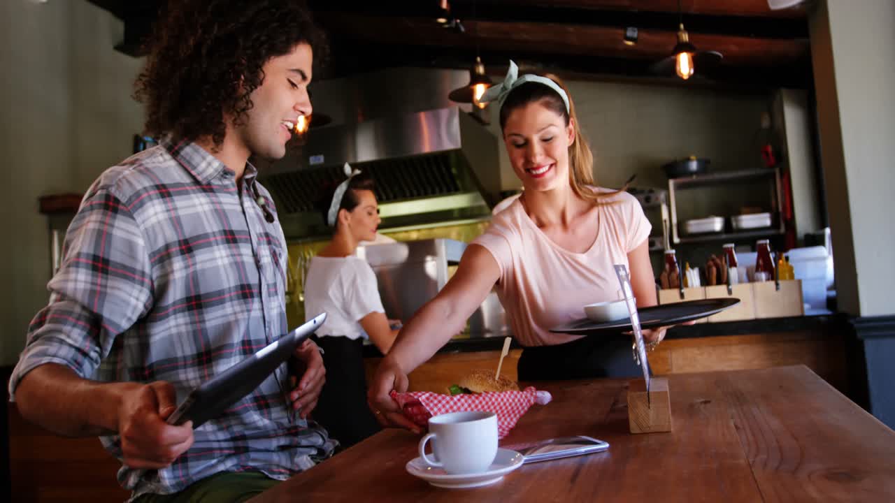 Waitress serving food to customer