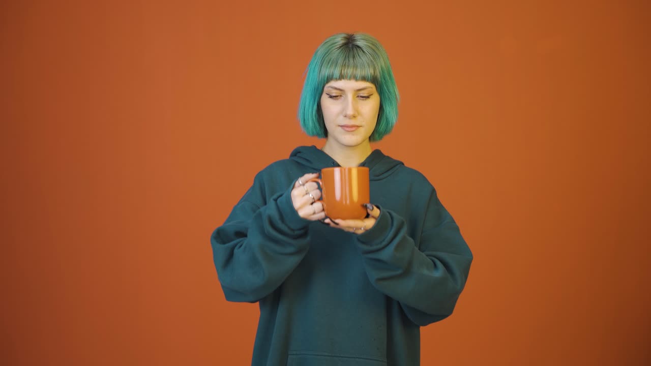 The young woman's mouth is burning from the hot drink.