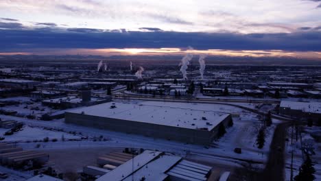 aerial shot of winter factory steaming pipes