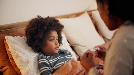 mother checking child's temperature