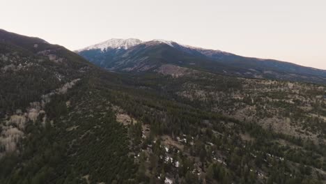 Drone-approaching-Mount-Princeton-in-the-Rocky-Mountains-in-Colorado-over-pine-trees-during-sunset