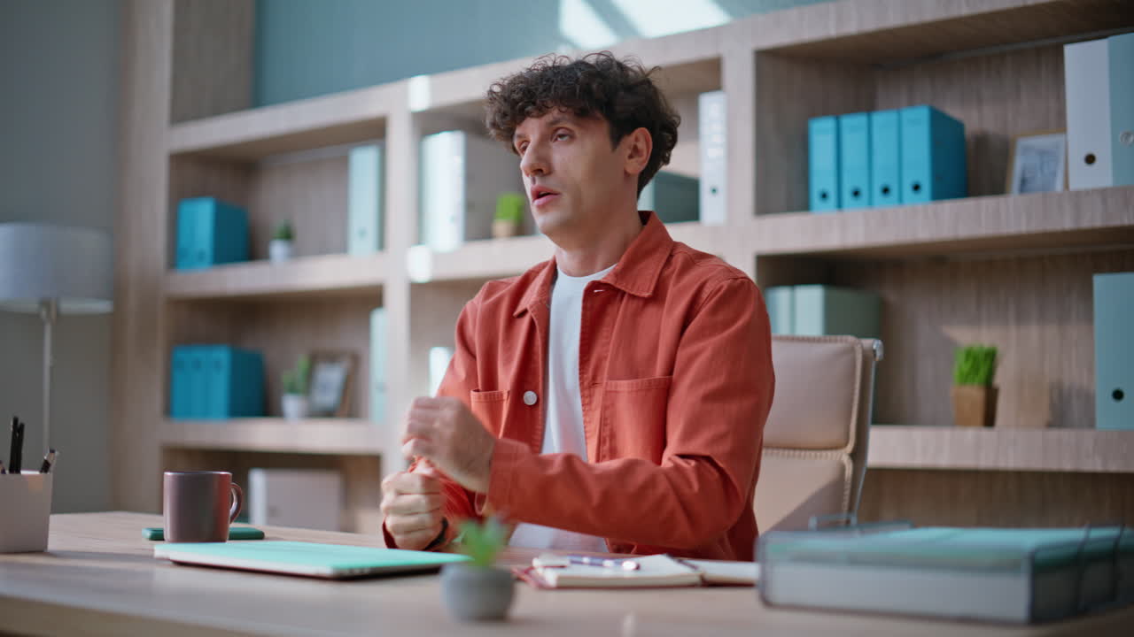 Irritated businessman talking virtual meeting gesturing to laptop webcam