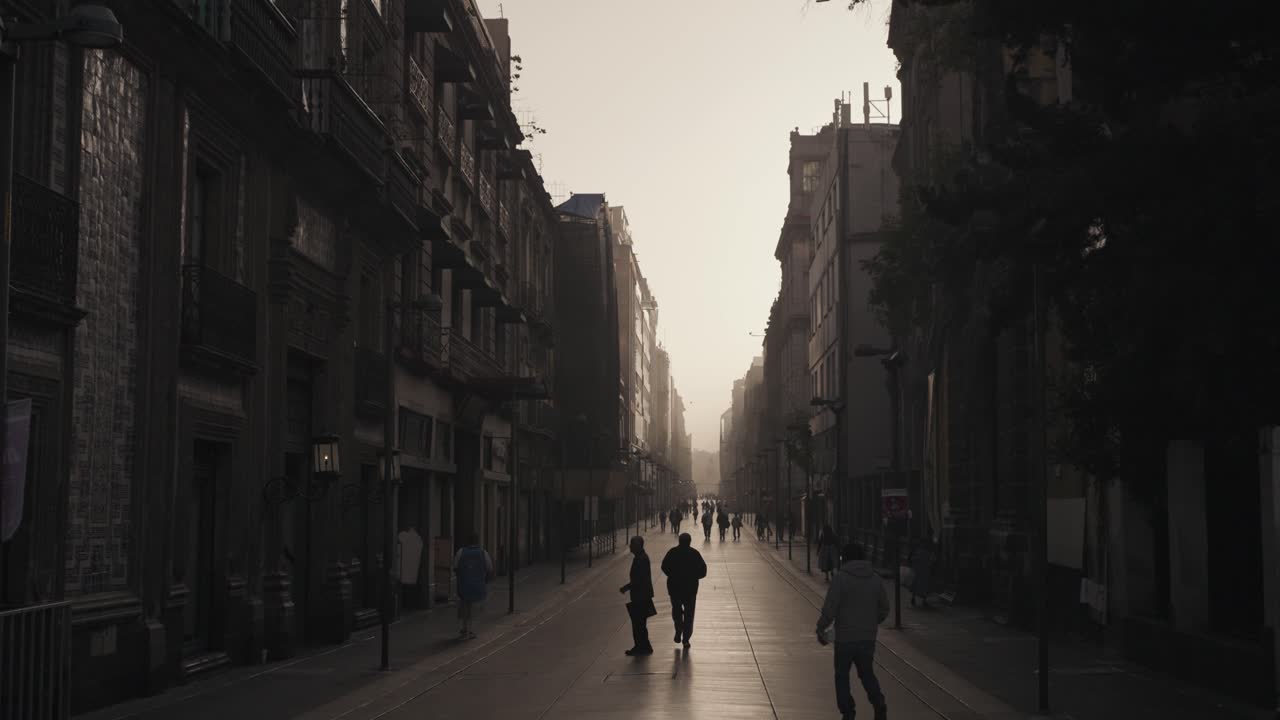 City street scene with people walking among old buildings