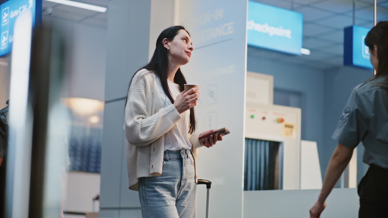 Woman Waiting at Airport Security Checkpoint
