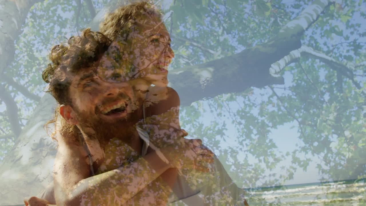 Animation of glowing light over woman practicing yoga against trees in background