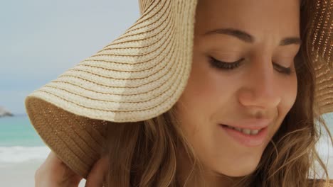 Close-up-of-Happy-Caucasian-woman-in-hat-standing-on-the-beach-4k