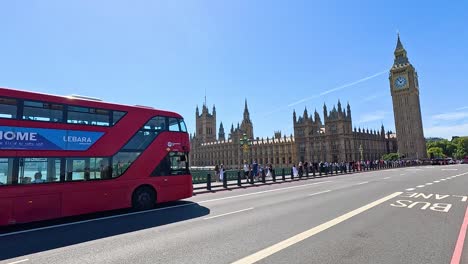 iconic red bus travels past big ben