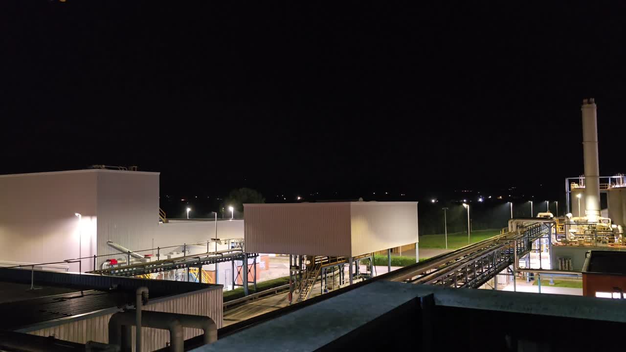 Chemical factory, general plan partial view of the factory, you can see a forklift (bull) working on a dark and starry night.