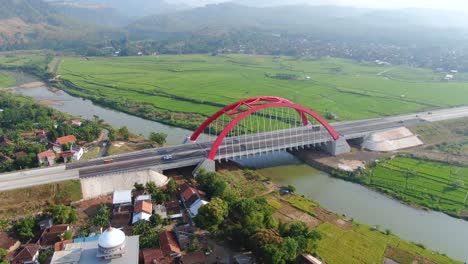 red kali kuto bridge on trans java toll road, indonesia, aerial orbital view