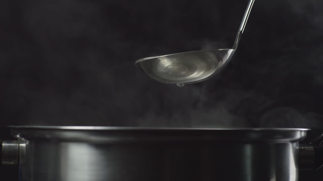 Close Up Of A Soup Cooking Process. Sukiyaki Or Shabu In A Pot, Cooking In Slow Motion On The Black Background