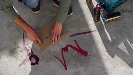 graffiti artist cutting cardboard with cutter 4k