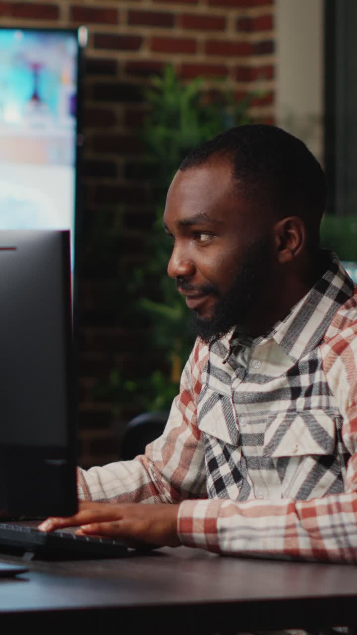 Vertical video: African american male artist working in studio office to create CGI production