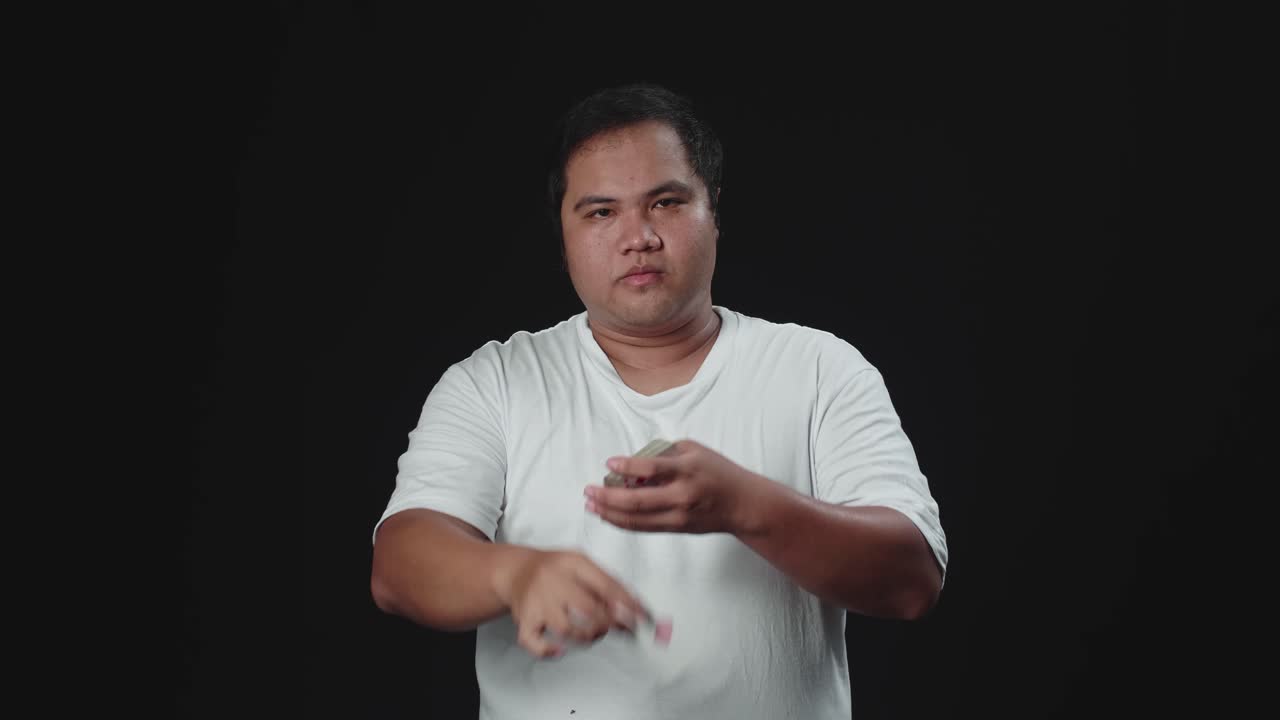 Asian Magician Performs Card Snap Change Trick. Sleight Of Hand