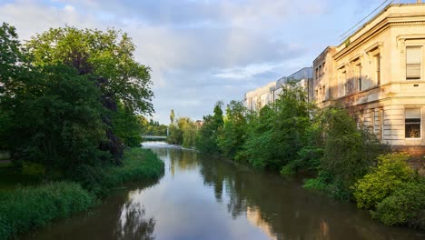 royal leamington spa timelapse van de rivier leam en jephson tuinen met snelstromend water dat de wolken weerkaatst en gedeeltelijke regenboog op een zomeravond, warwickshire, engeland, uk