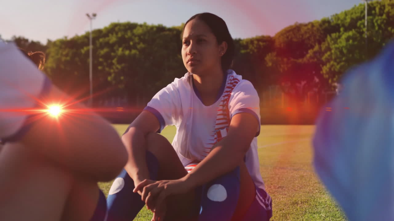 Sitting on grass, woman in sports attire enjoying sunlight in park