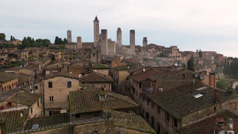 ancient stone houses and towers during sunrise in san gimignano, tuscany, north-central italy