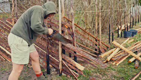 timelapse of man building skigard or traditional fence in norway