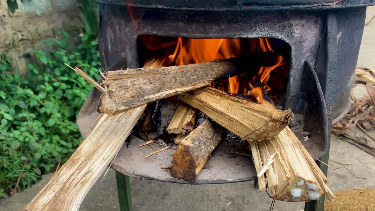 Close up for old and beat up cooking pan door full of wood flame and smoke