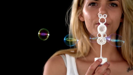 pretty blonde blowing many bubbles