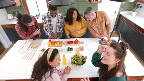 Happy-diverse-male-and-female-friends-celebrating-thanksgiving-day