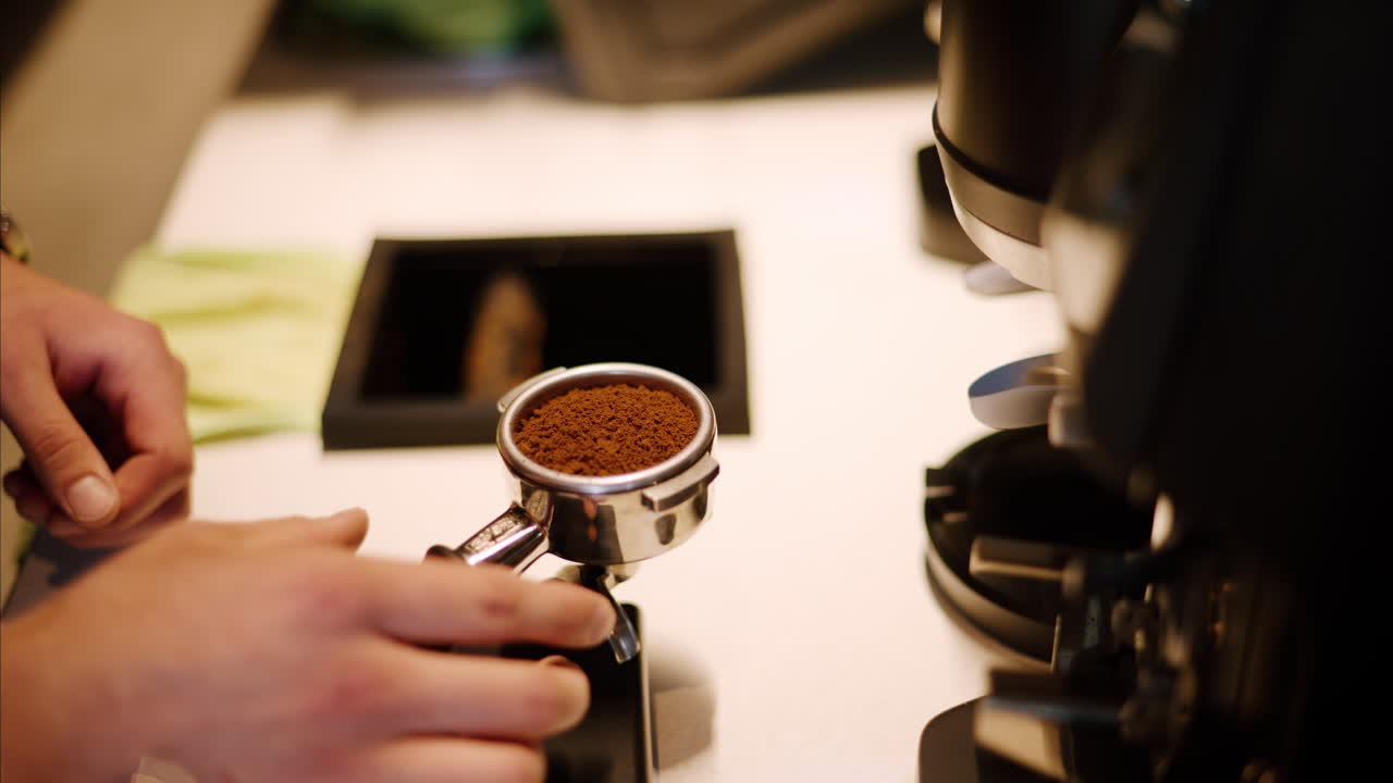 Barista preparing the grounded coffee at a cafe