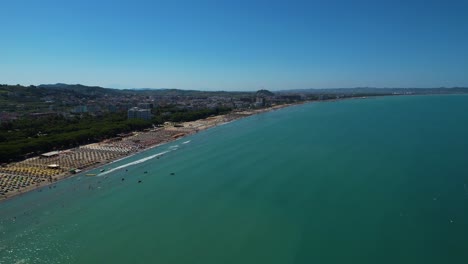 adriatic coastline in durres, albania with beach surrounded by green pines, hotels, and resorts for summer sunbathing holidays