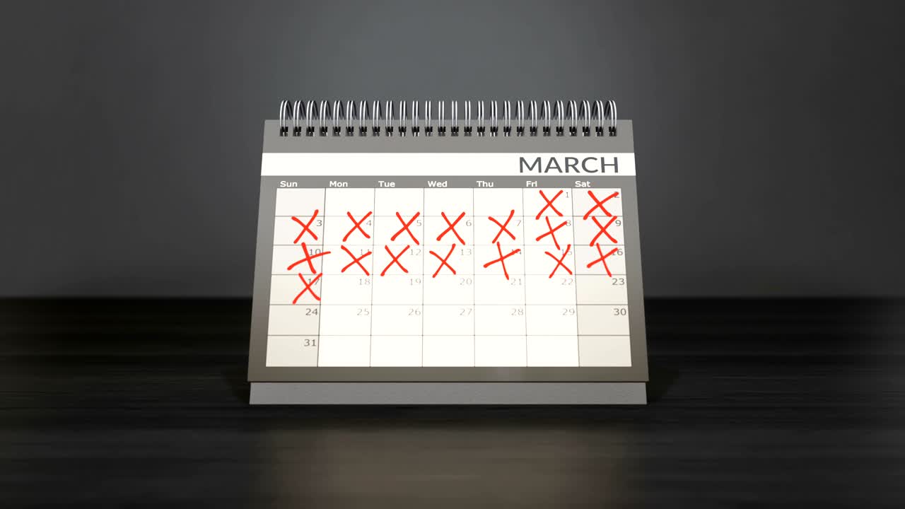 Flagged days in monthly calendar on desk year calendar.
