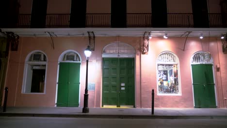 historic new orleans building front illuminated by urban streetlamp at night