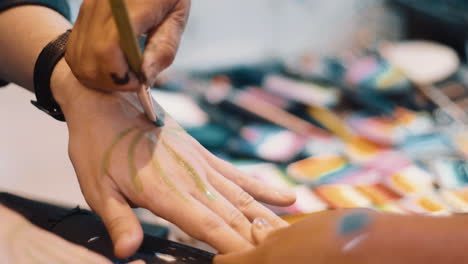 Painting-on-someone's-hand-at-a-festival