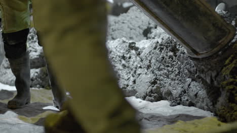 pouring cement down the chute onto a foundation at a construction site