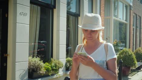 woman with a smartphone walking in delft