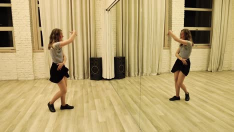 slow motion talented teenage female dancer dancing in front of a mirror