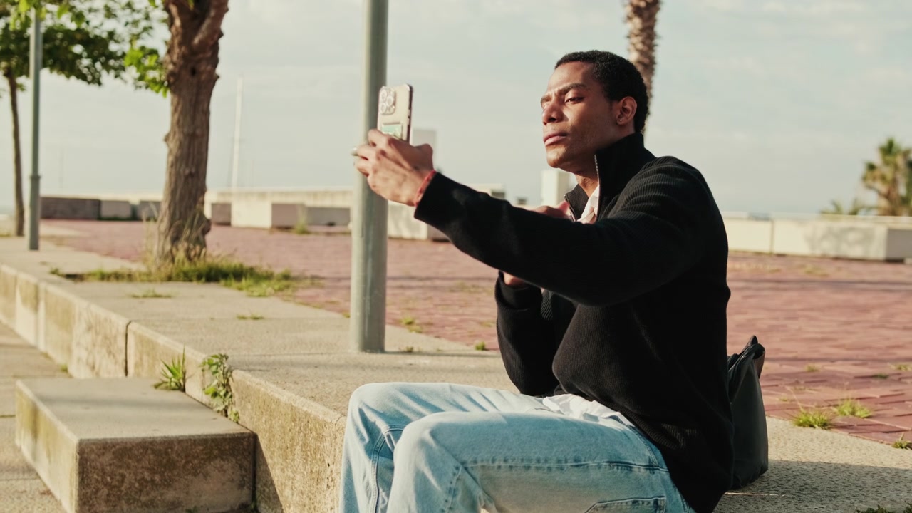 Young Man Taking a Selfie with Smartphone Outdoors