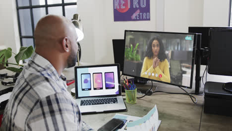 African-american-businessman-on-video-call-with-african-american-female-colleague-on-screen