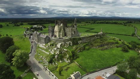 Aerial-drone-shot-of-castle-and-grassy-landscapes-in-Ireland