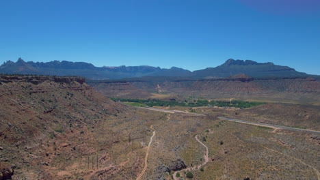 aerial view of mount zion mountain range with road running through it located in southern utah