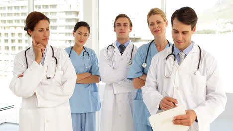 medical team looking at camera and each other