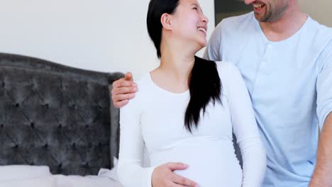 pregnant couple interacting with each other in bedroom 4k