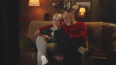senior couple watching tv at home