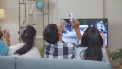 asian teenagers friends playing racing video game at home and disappointed, tv display