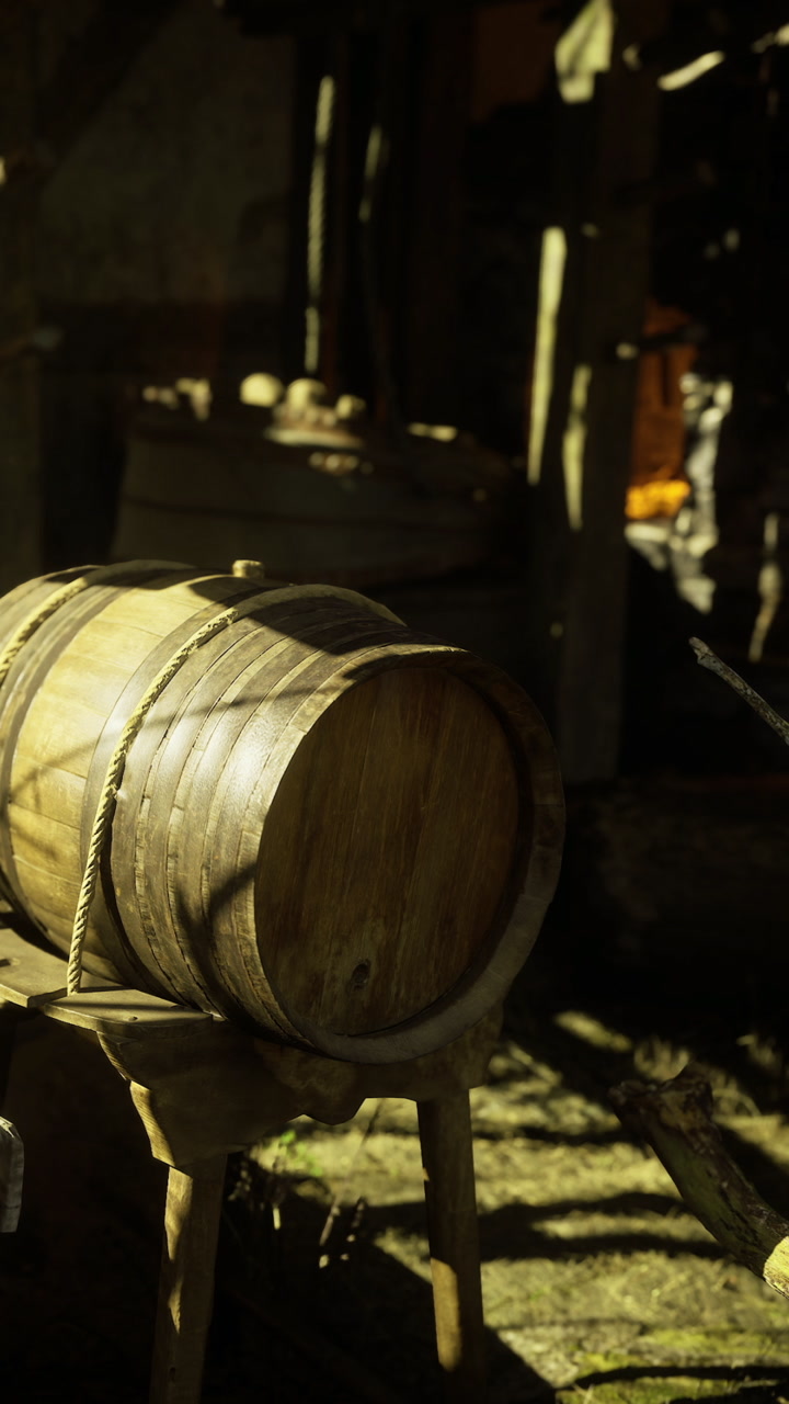 Wooden barrel resting on a stand in a rustic workshop during golden hour