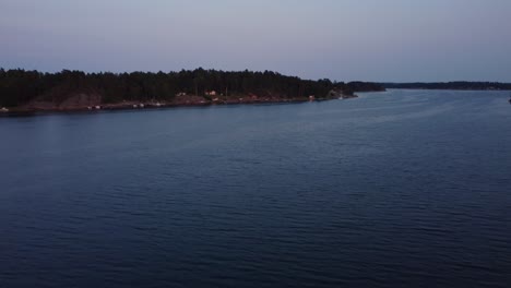 blue hour hues over stockholm archipelago, calm water and distant shoreline
