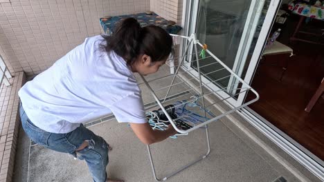 person hanging clothes on a drying rack